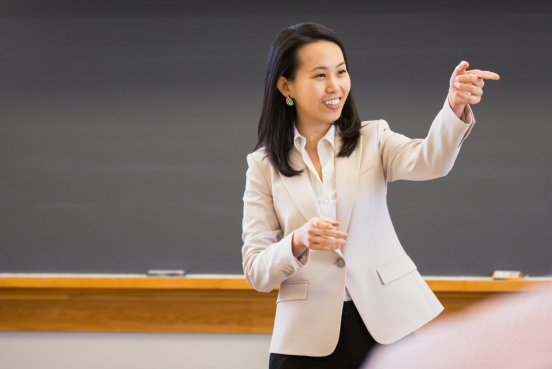 A lecturer pointing at the class